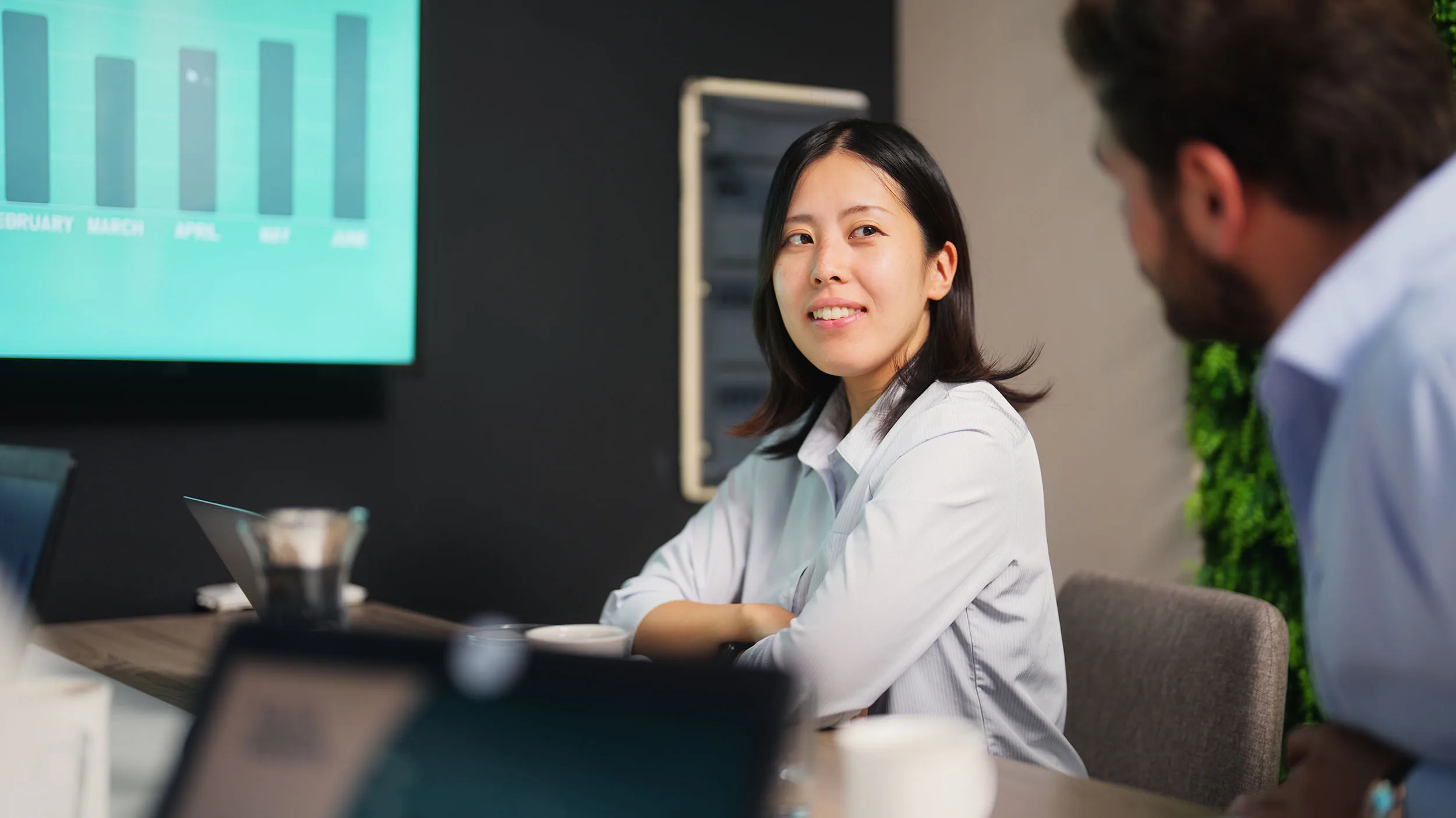 Young businesswoman attending business meeting in meeting room in modern office working space